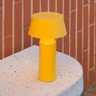 The Bicoca Portable Table Lamp from Marset in yellow in a home office.