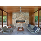 The Altus suspended ceiling fan from The Modern Fan Co. in a living room with a fireplace.