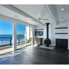 The Ball ceiling fan from The Modern Fan Co. in a living room next to the beach.