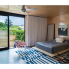 The Ball Flush ceiling fan from Modern Fan Co. with a 52" blade with a brushed aluminum body with aluminum color blades in a bedroom.