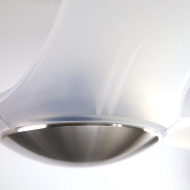 The bright nickel and translucent IC/Brisa DC - 56″ from Modern Fan Co. shown close up in a living room.