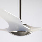 The bright nickel and translucent IC/Brisa DC - 56″ from Modern Fan Co. in a close up within a studio.