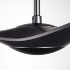 The matte black IC/Brisa DC - 56″ from Modern Fan Co. in a view from the side within a studio.