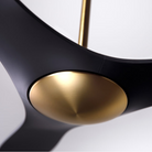 The satin brass and matte black IC/Brisa DC - 56″ from Modern Fan Co. shown in detail within a family area.