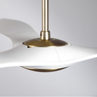 The satin brass and matte white IC/Brisa DC - 56″ from Modern Fan Co. shown from the side in a family area.