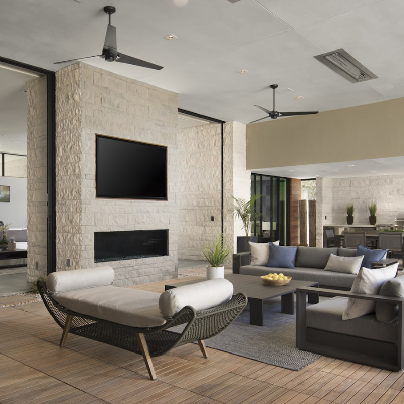 The Torsion 20W LED—62" within a lounge area from Modern Fan Co.