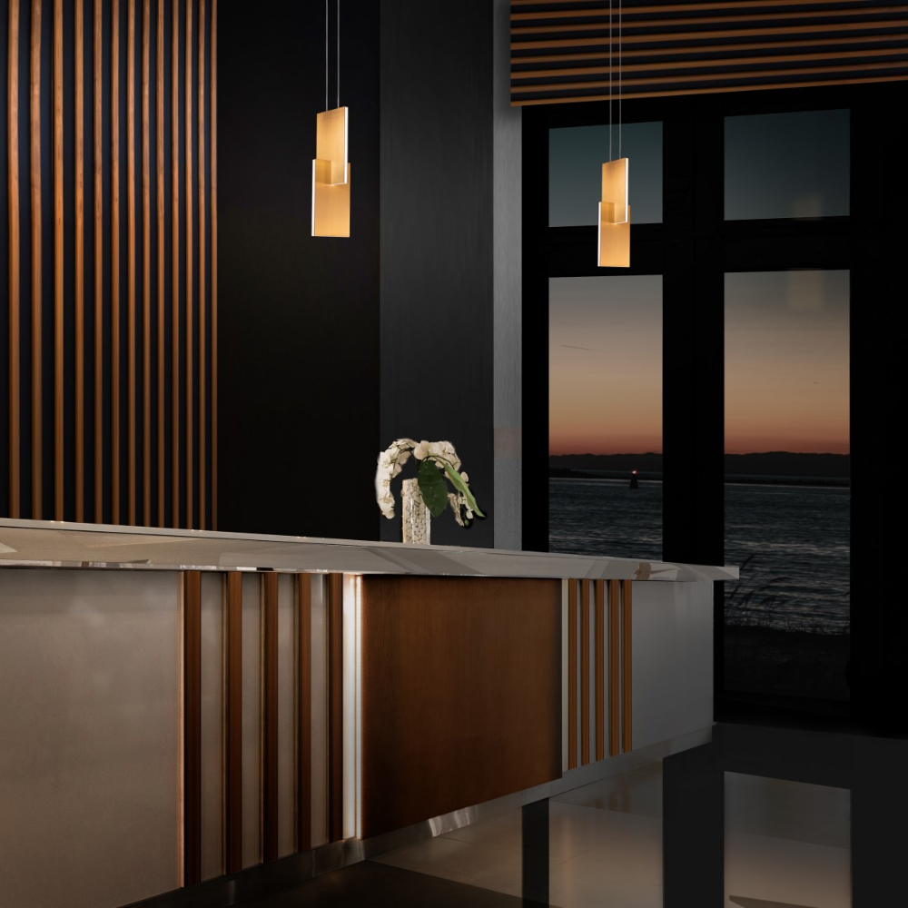 The aged brass Amari Pendant Light from Modern Forms in a living room.