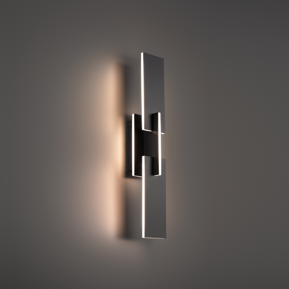 The black Amari Wall Sconce from Modern Forms in a family area.