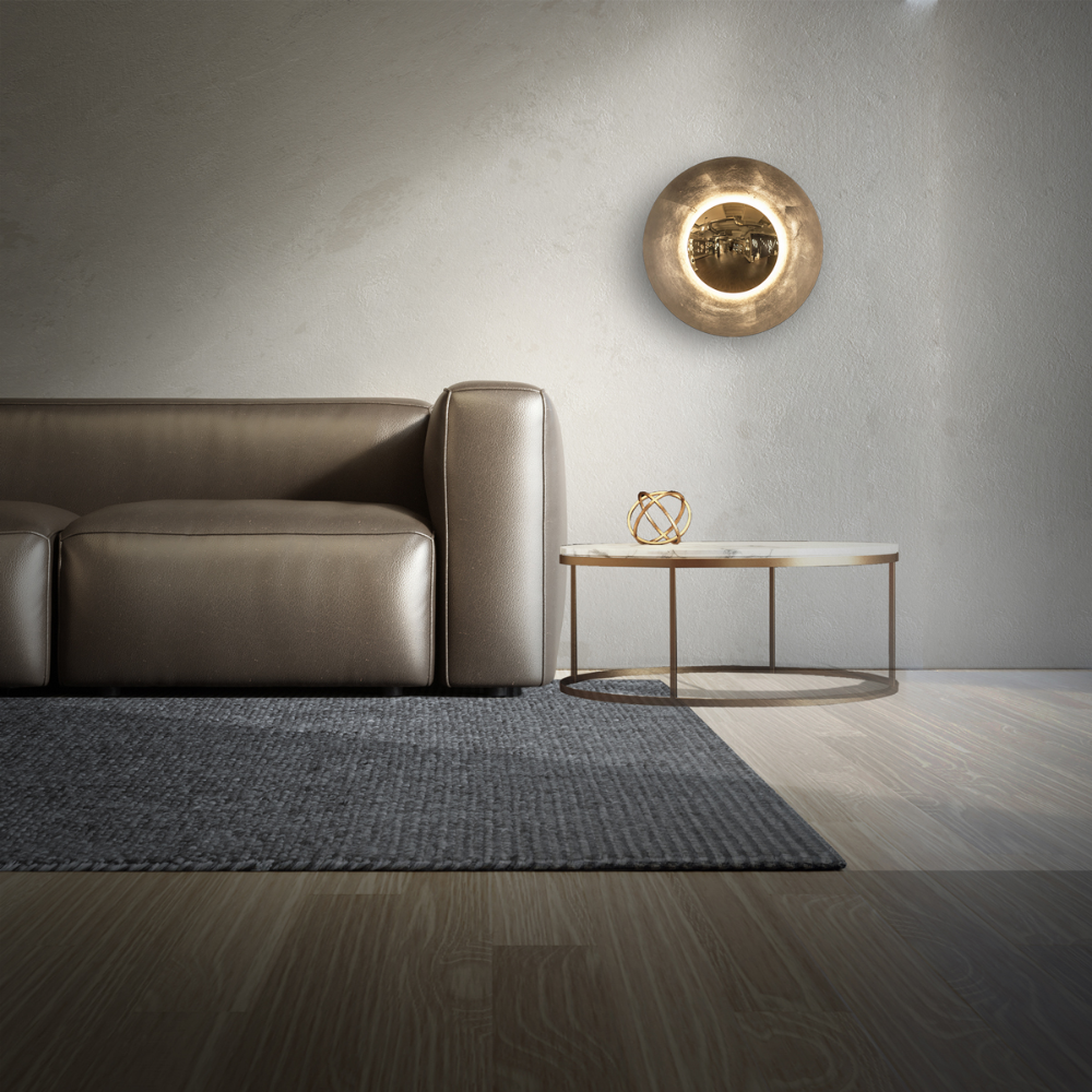 The gold leaf Blaze Wall Sconce from Modern Forms in a living room.