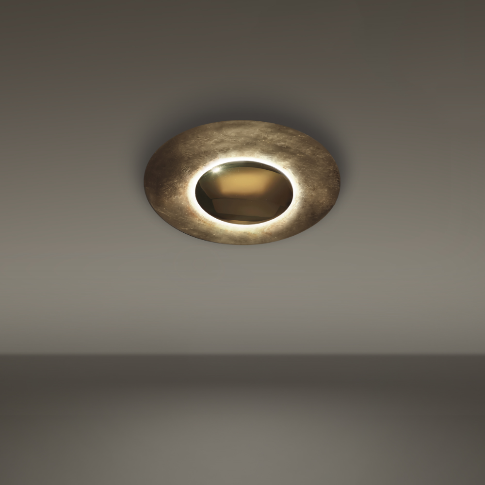 The gold leaf Blaze Wall Sconce from Modern Forms on a studio ceiling.