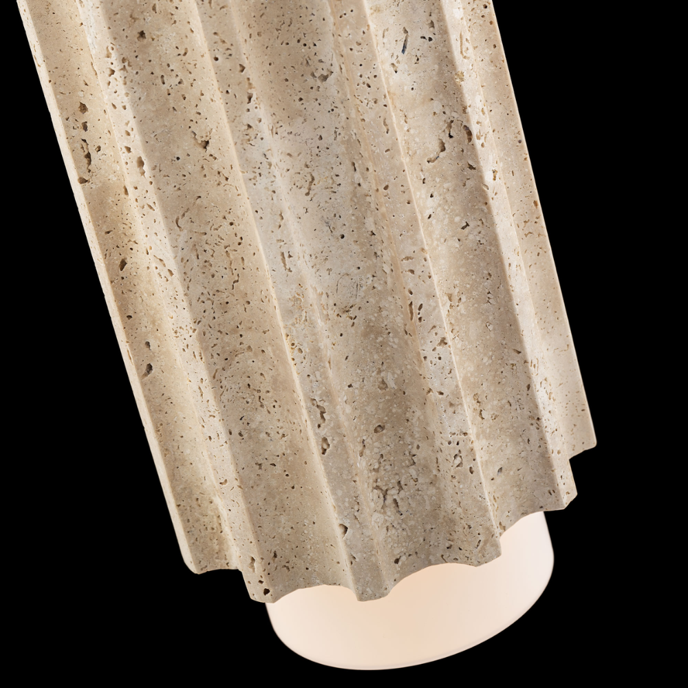 The beige travertine and aged brass Caviar Pendant Light from Modern Forms in a dark bedroom.