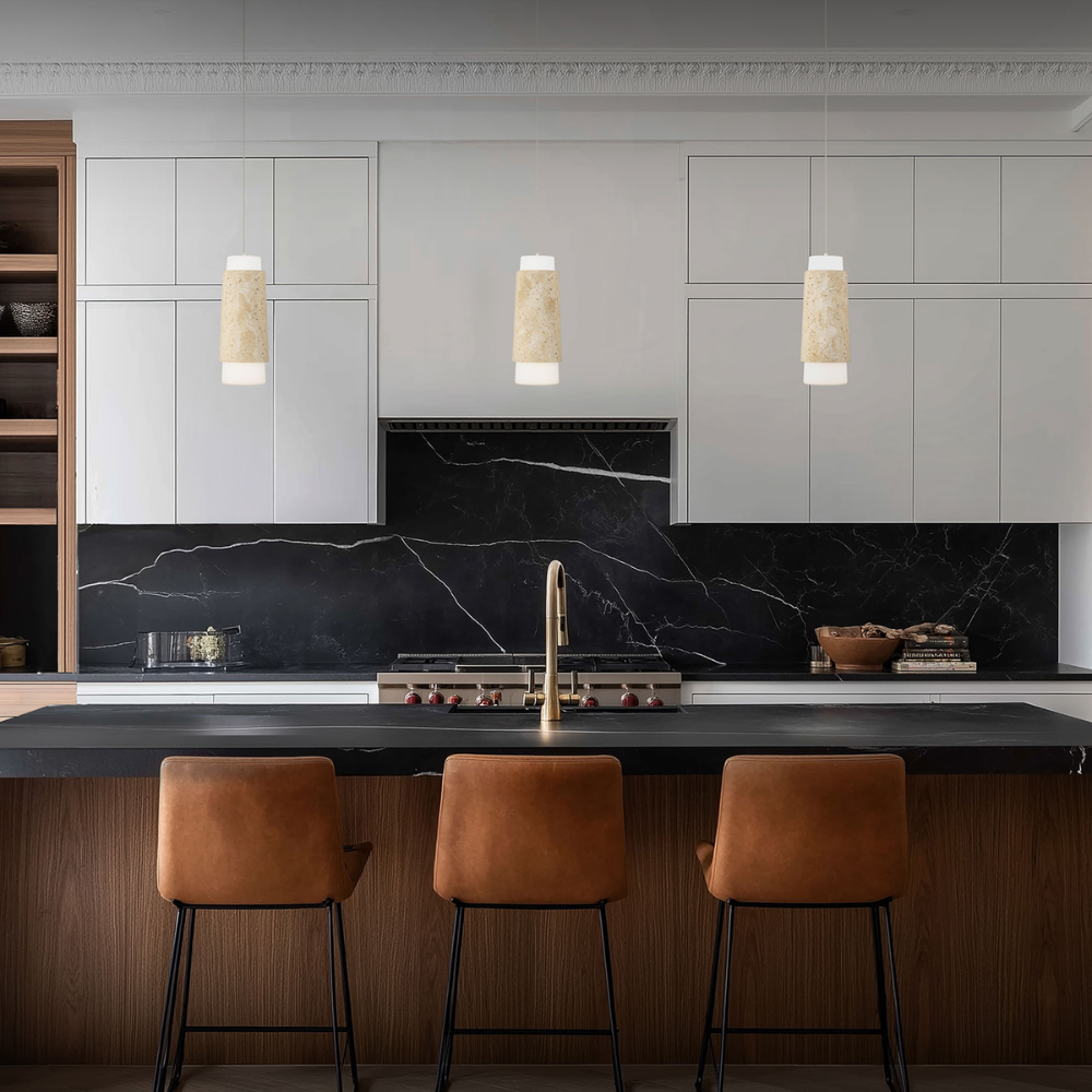 The beige travertine and aged brass Chauncey Pendant Light from Modern Forms in a kitchen and dining space.