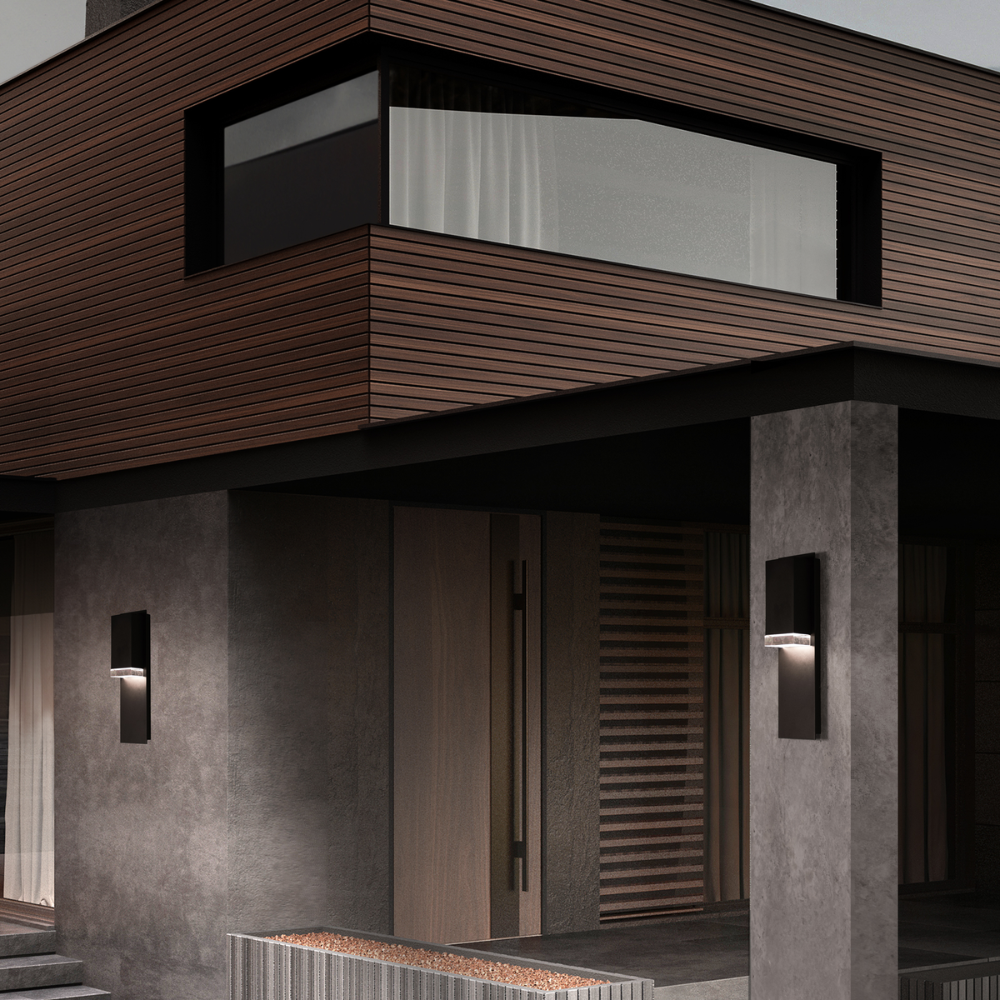 The medium Draped Wall Sconce from Modern Forms illuminating an outdoor entryway.