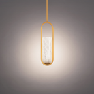 The aged brass Rollins Pendant Light from Modern Forms in a studio.