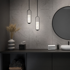 The black Rollins Pendant Light from Modern Forms in a bathroom.