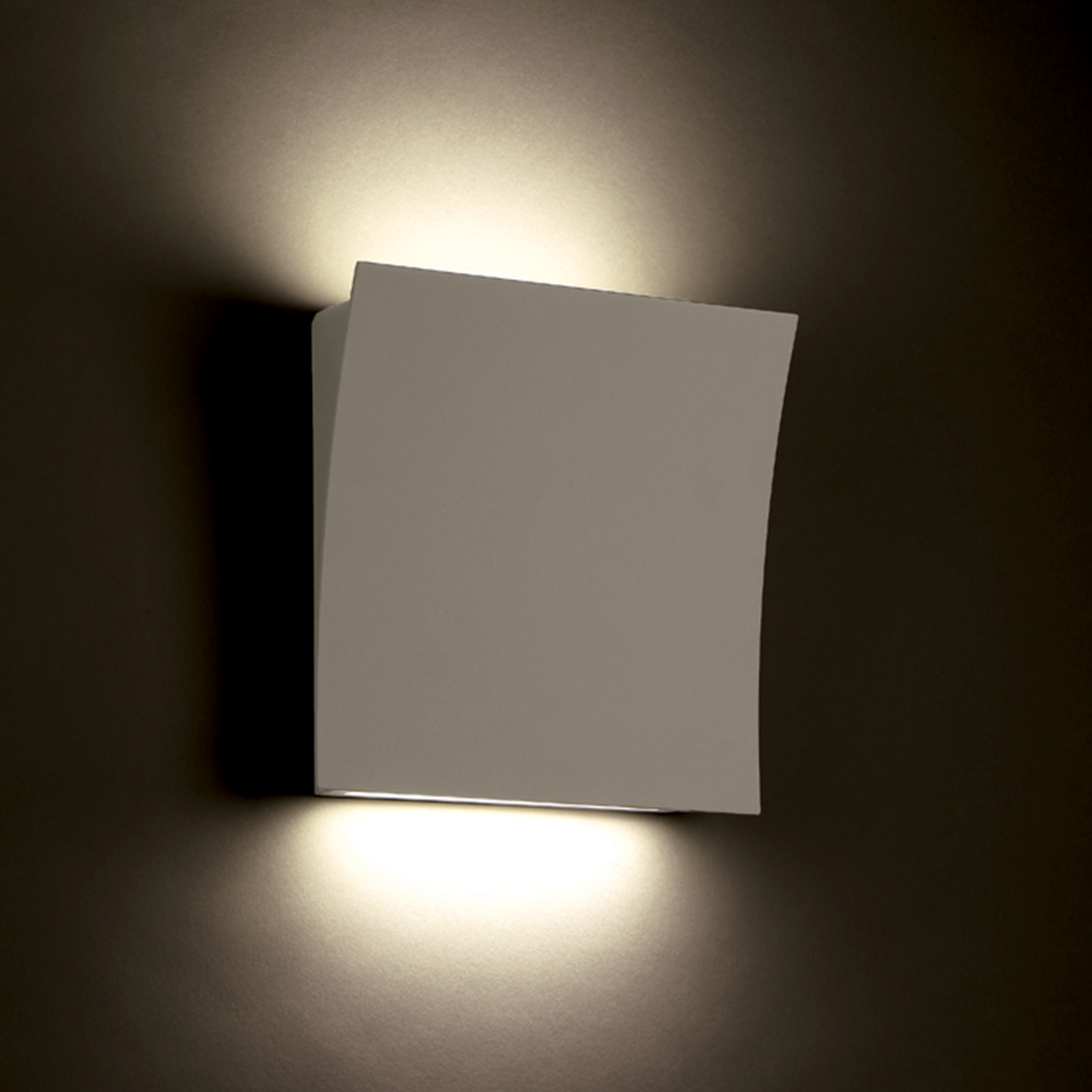 The white Slide Wall Sconce from Modern Forms in a living room.