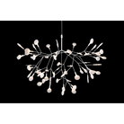 The white Heracleum III Suspended from Moooi in a dark room.