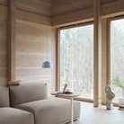 The light blue Ambit Pendant Lamp from Muuto in a living area.