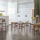 The light blue Ambit Pendant Lamp from Muuto in a restaurant.