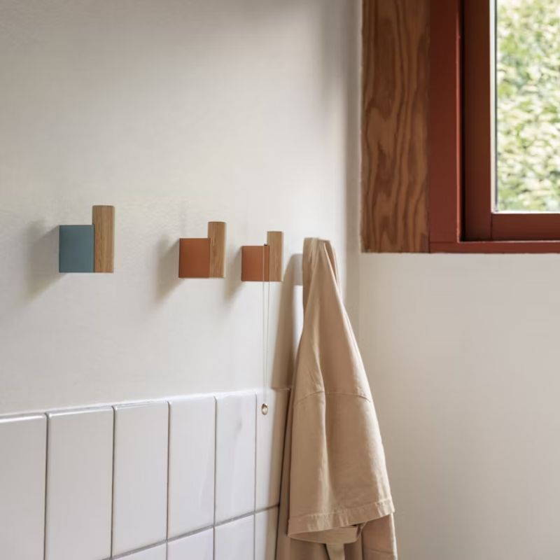 Muuto Attach Wall Hook in Oak in a bathroom being used to hang towels. all-groups