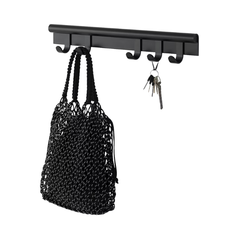 The Coil Coat Rack Small Black from Muuto with the hanging items.