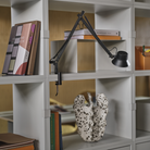 The black Dedicate Table Lamp from Muuto in a home office.