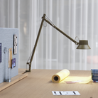 The brown green Dedicate Table Lamp from Muuto in a business space.