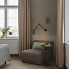 The  black Dedicate Wall Lamp from Muuto in a primary bedroom. all-groups