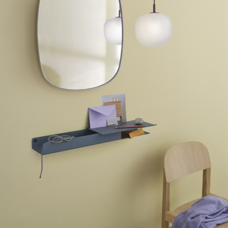 Folded shelf with platform tray blue grey in a bedroom.
