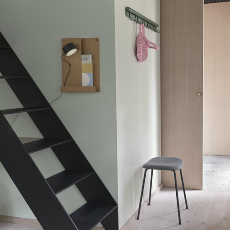 The 11 inch Folded Shelves from Muuto in Burnt Orange near the ladders in a hallway.
