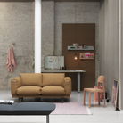 The Folded Shelves from Muuto in grey and burnt orange in a living room.