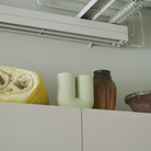The Kink Vase Light Green from Muuto in a living room.
