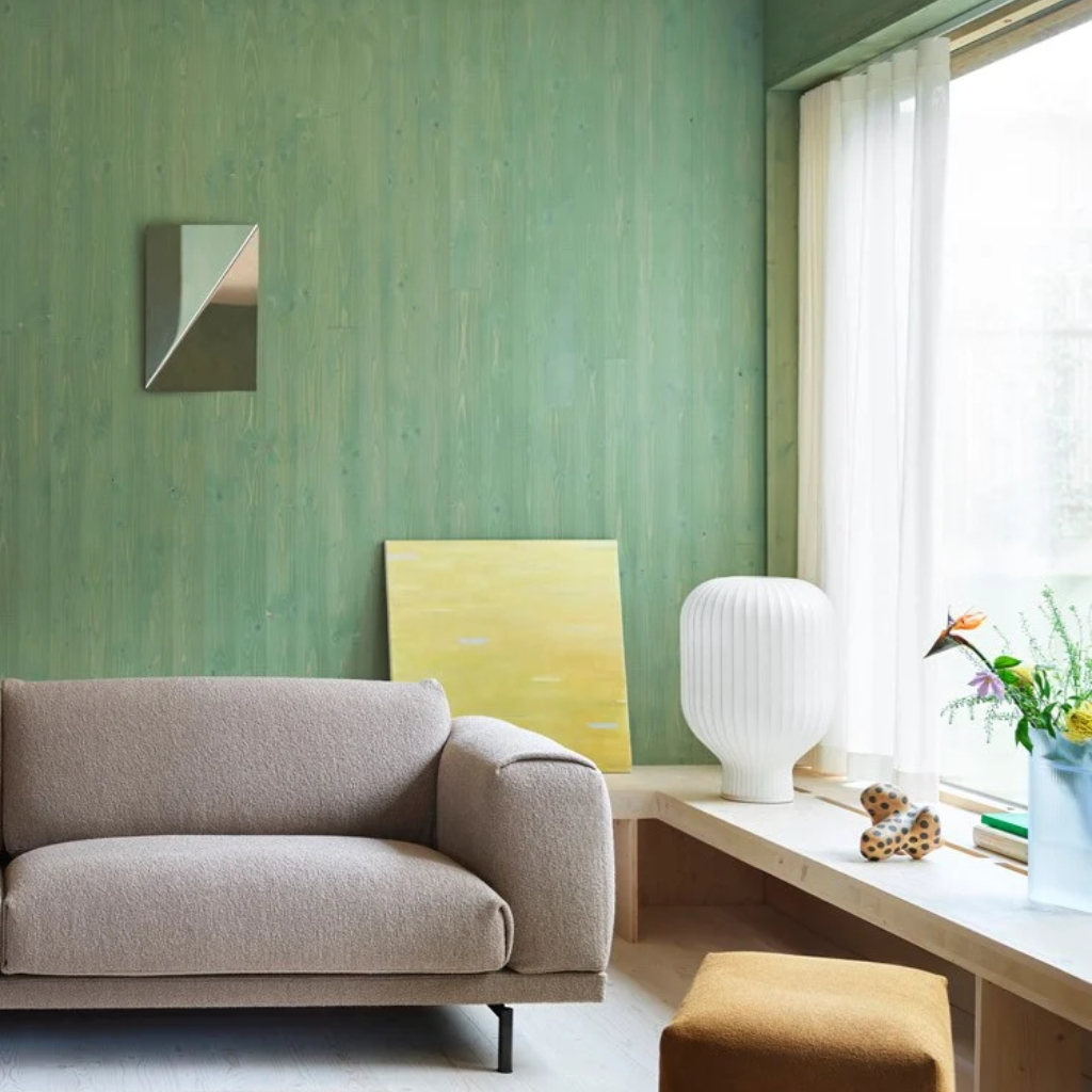 Muuto sofa in a living room with green walls