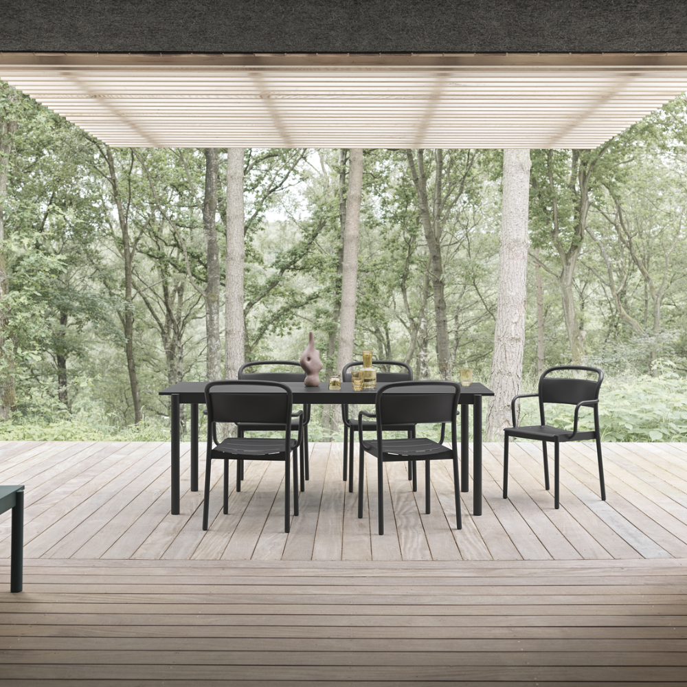 The black Linear Steel Table from Muuto in a dining room.