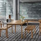 The burnt orange Linear Steel Table from Muuto used in an outdoor cafe.
