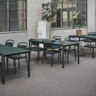 The dark green Linear Steel Table from Muuto in a commercial area.