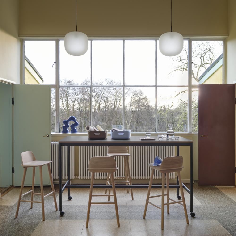 The oak Nerd Bar Stool from Muuto in a living room.