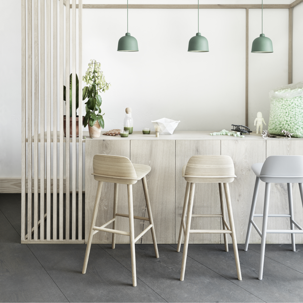 The gray Nerd Counter Stool from Muuto in a kitchen and dining area.