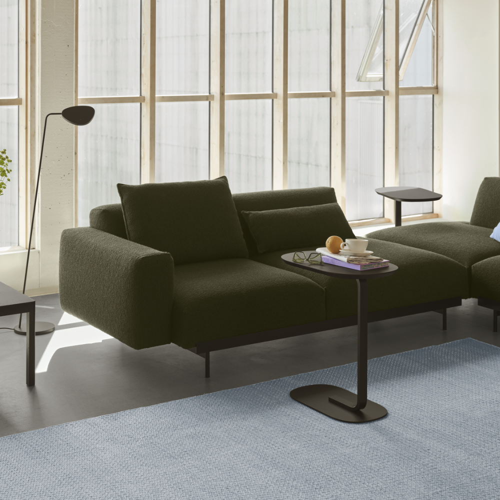 The black Relate Side Table from Muuto in a living room.
