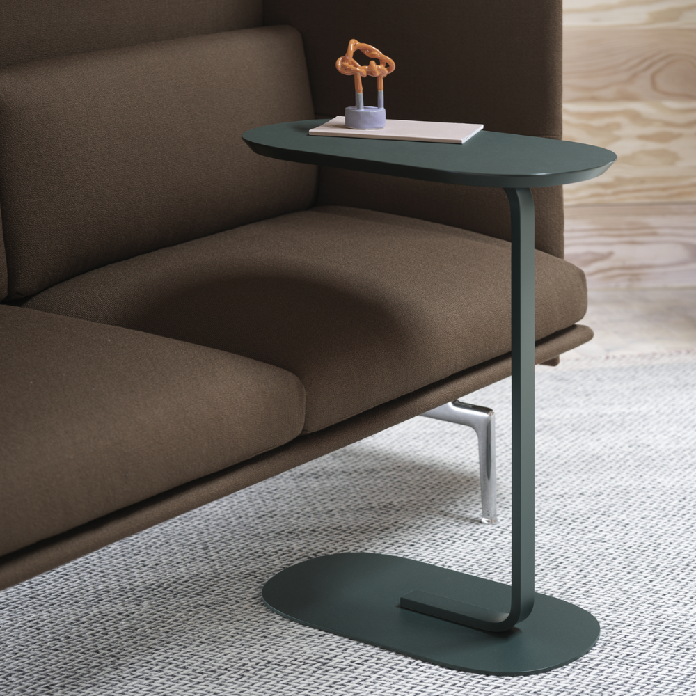 The dark green Relate Side Table from Muuto in a living space.