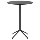 The 41 inch Still Round Cafe Table from Muuto with the black nanolaminate table top and black frame.