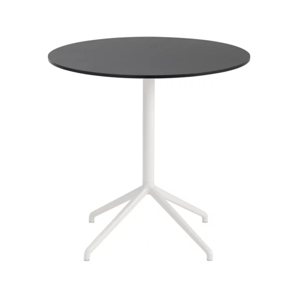 The 29 inch Still Round Cafe Table from Muuto with the black nanolaminate table top and white frame.