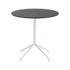 The 29 inch Still Round Cafe Table from Muuto with the black nanolaminate table top and white frame.
