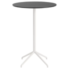 The 41 inch Still Round Cafe Table from Muuto with the black nanolaminate table top and white frame.