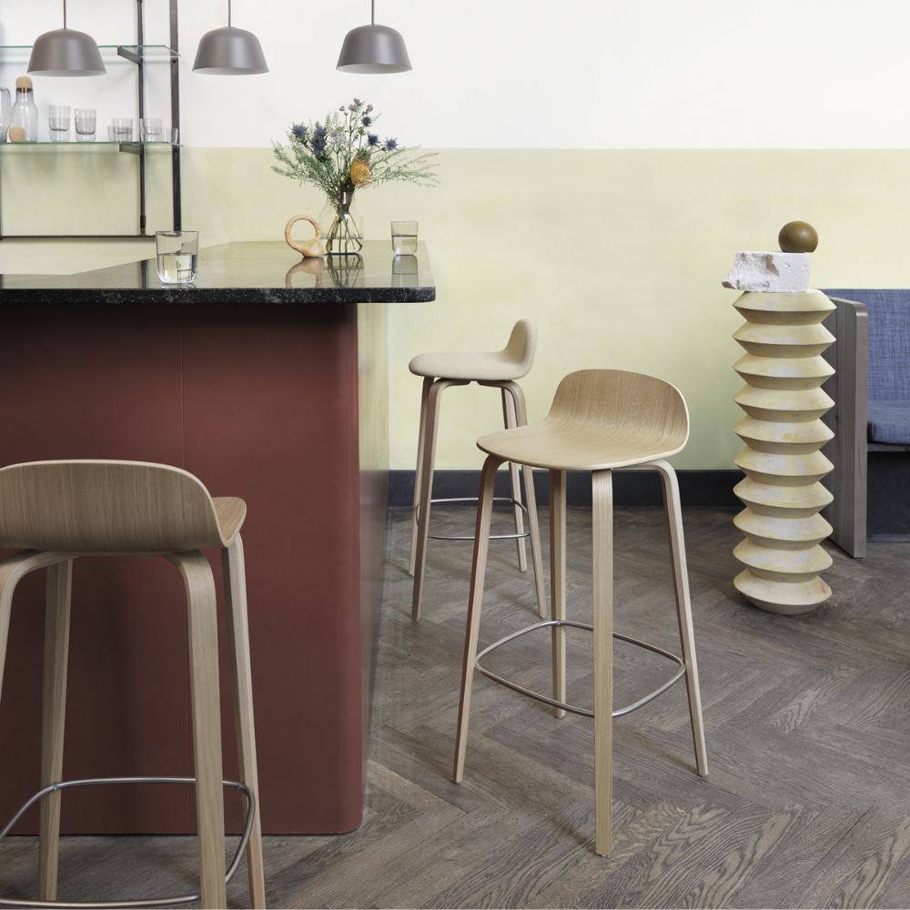 The oak Visu Counter Stool from Muuto in a dining room.