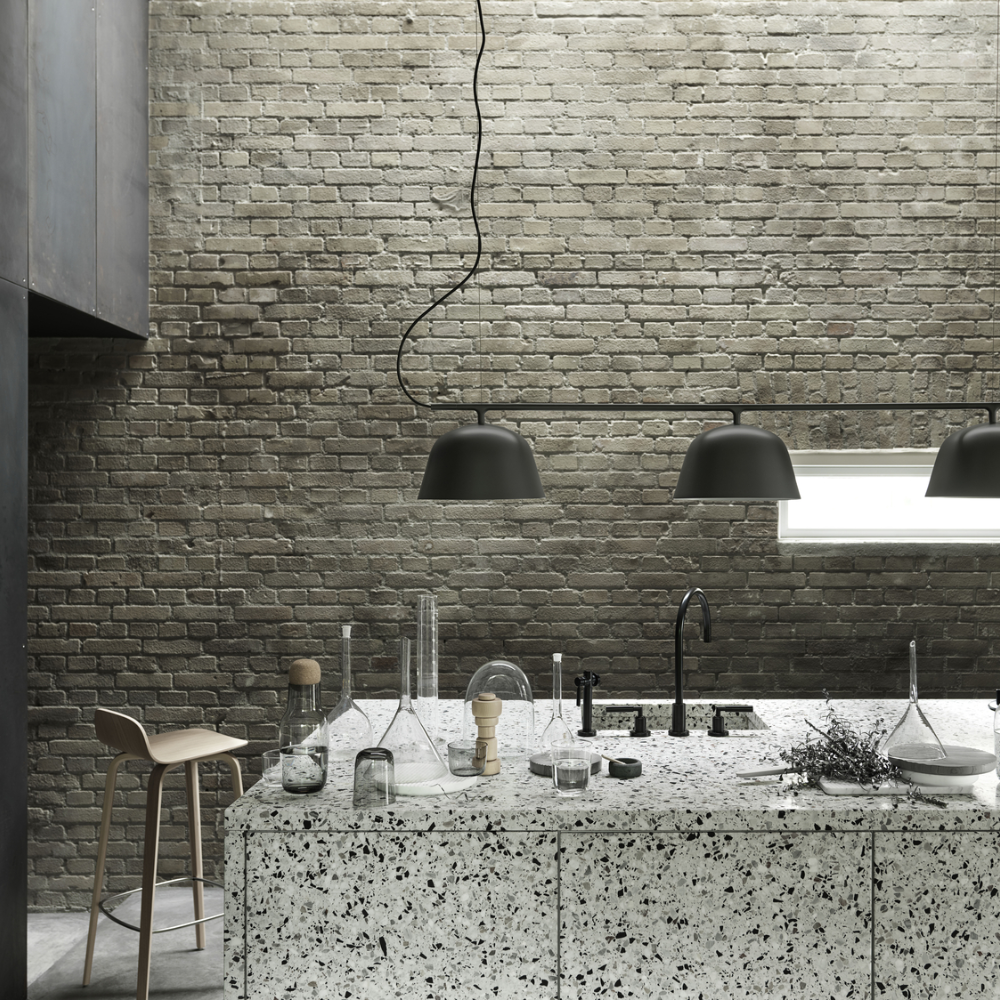 The oak Visu Counter Stool from Muuto in a kitchen and dining area.