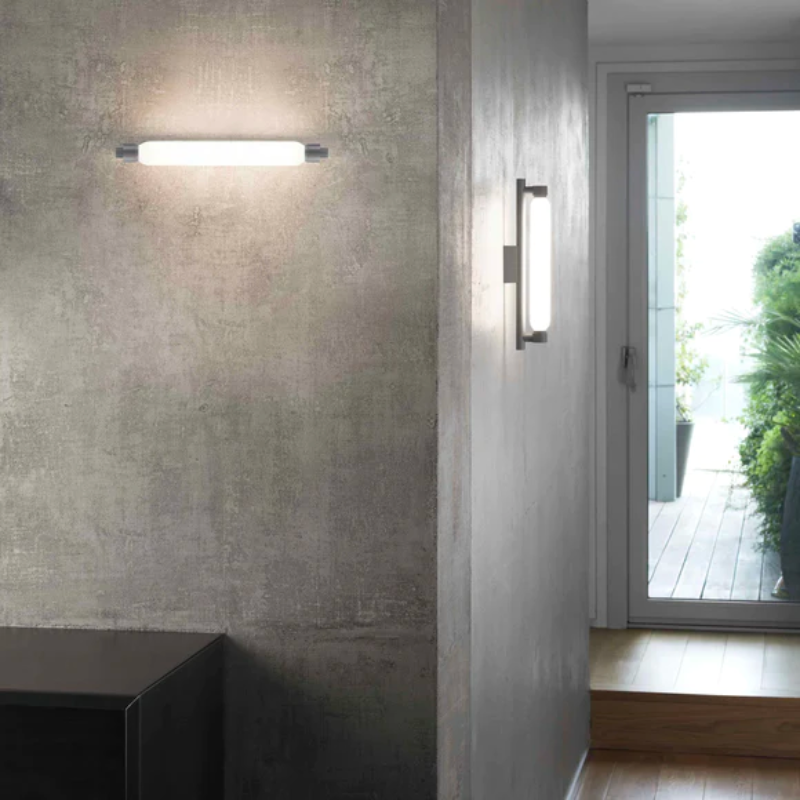 The La Roche Wall Sconce from Nemo in gray in a hallway.