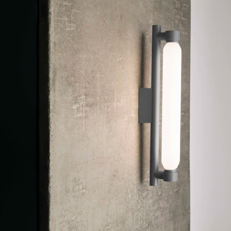 The La Roche Wall Sconce from Nemo in gray in a living room.
