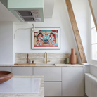 The Lampe de Marseille Mini Wall Sconce from Nemo in whitewash in a kitchen.