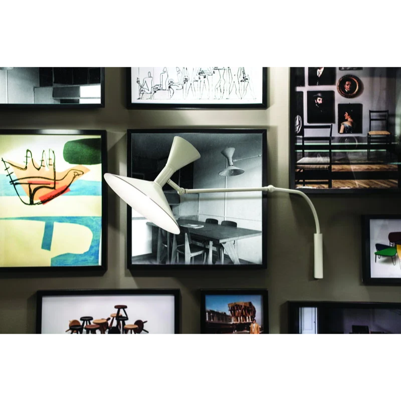 The Lampe de Marseille Mini Wall Sconce from Nemo in whitewash in an art studio.